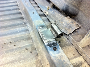 Hinge piece welded to underside of truck bed